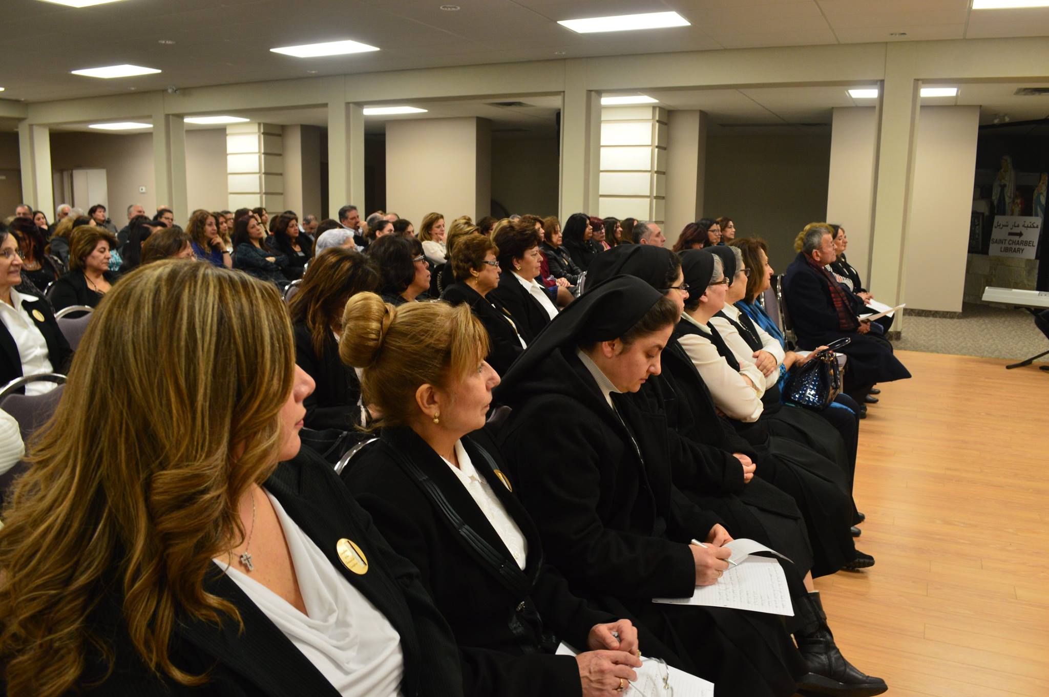 Parishioners and sisters listening intently during a gathering