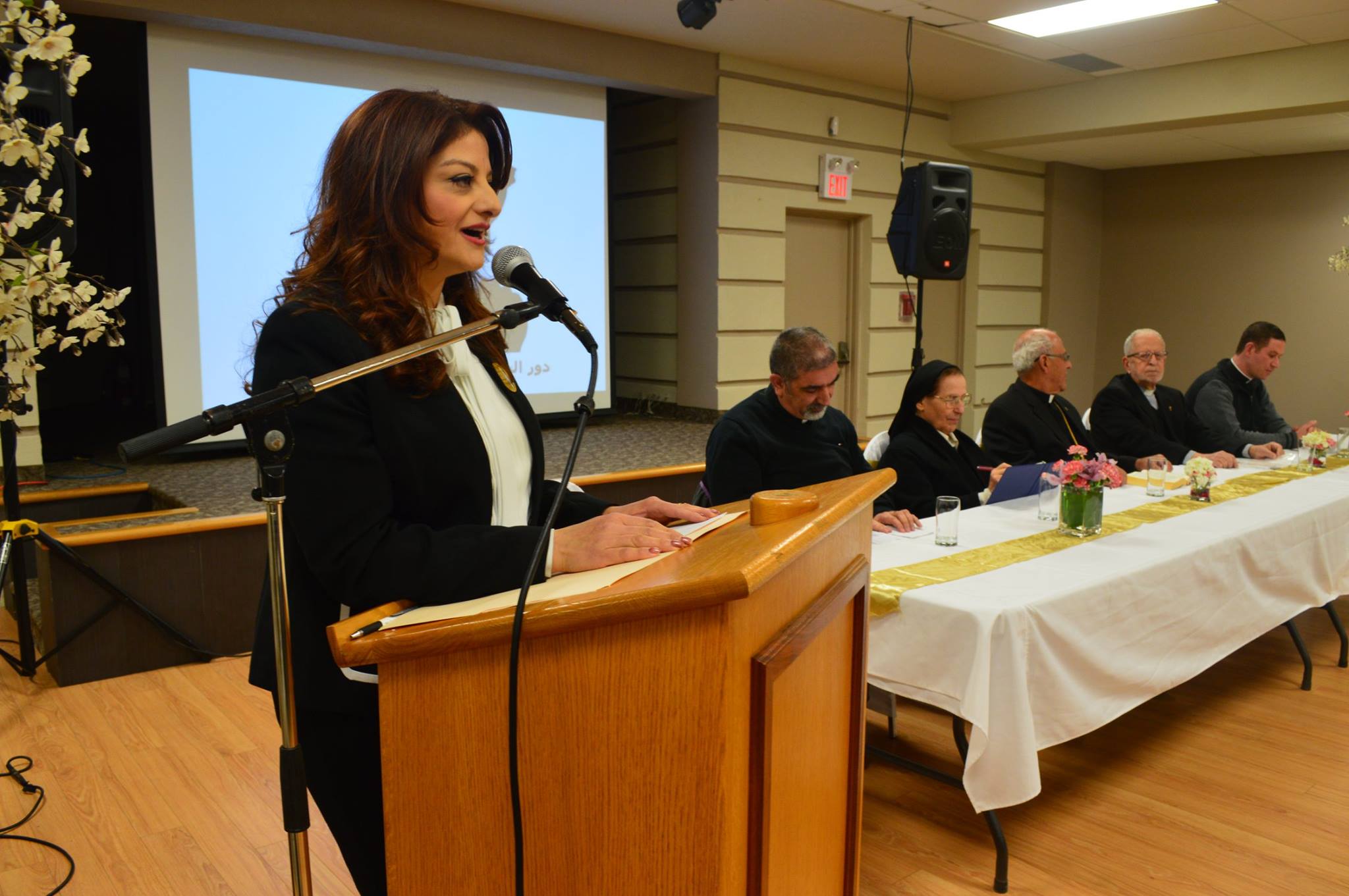 President addressing a community assembly from the podium