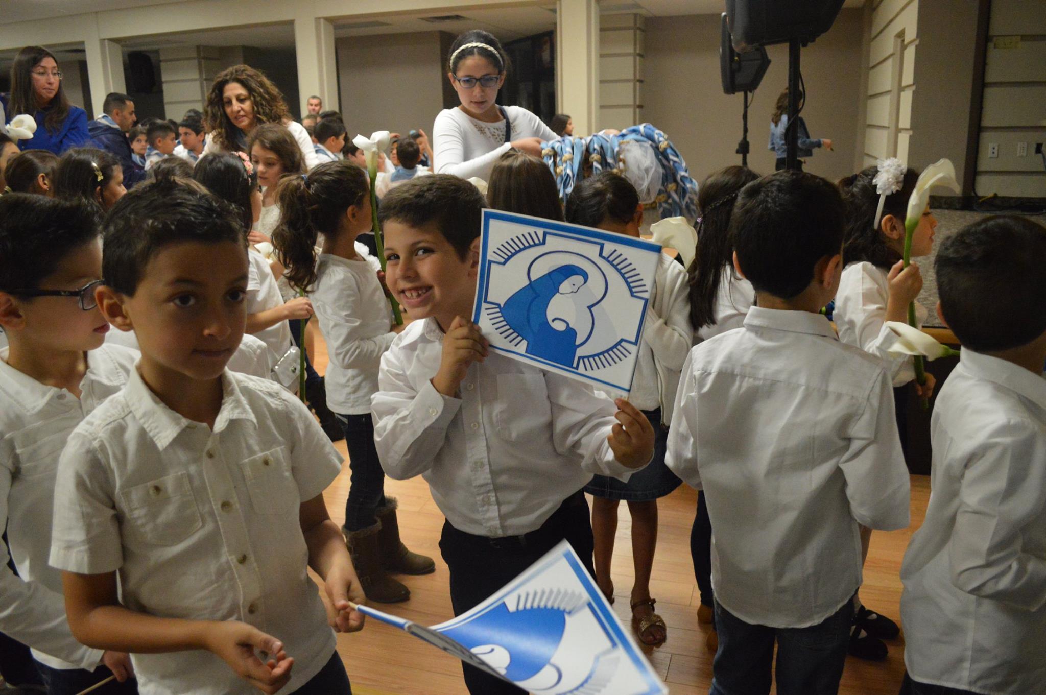 Fersan kids carrying Marian flags during a procession